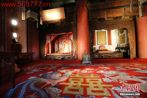 资料图：帝后大婚原状陈列的红色锦缎龙凤床帏、地毯，乃至挂在墙上的对联贴落。